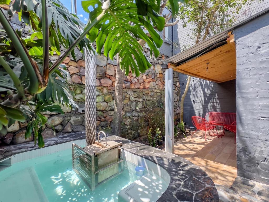 a swimming pool in a backyard with a house at Lily of the Valley - Higgovale in Cape Town