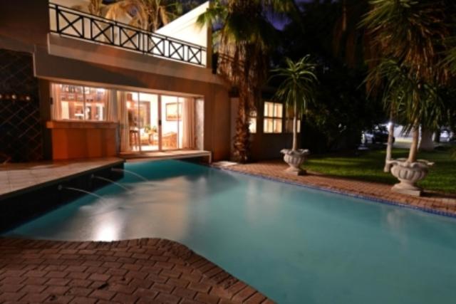 a large swimming pool in front of a house at Carters Rest Guesthouse in Kimberley