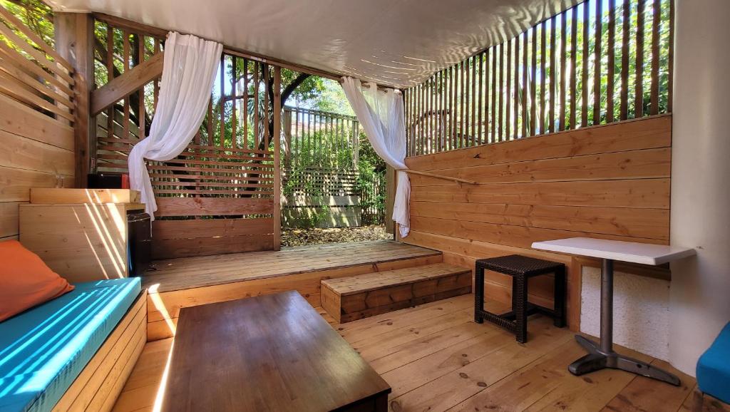 a wooden cabin with a bench and a table at Le Lodge du Cap Ferret in Cap-Ferret