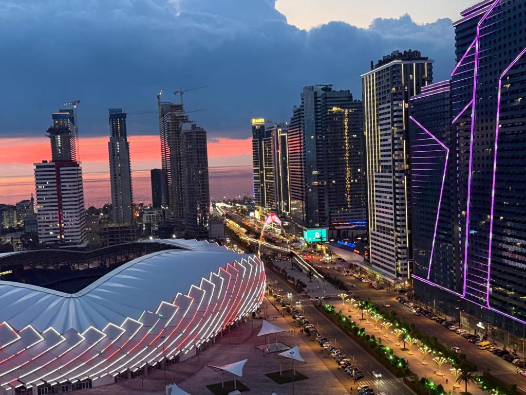 a view of a city at night with buildings at Fantastico 270 in Batumi