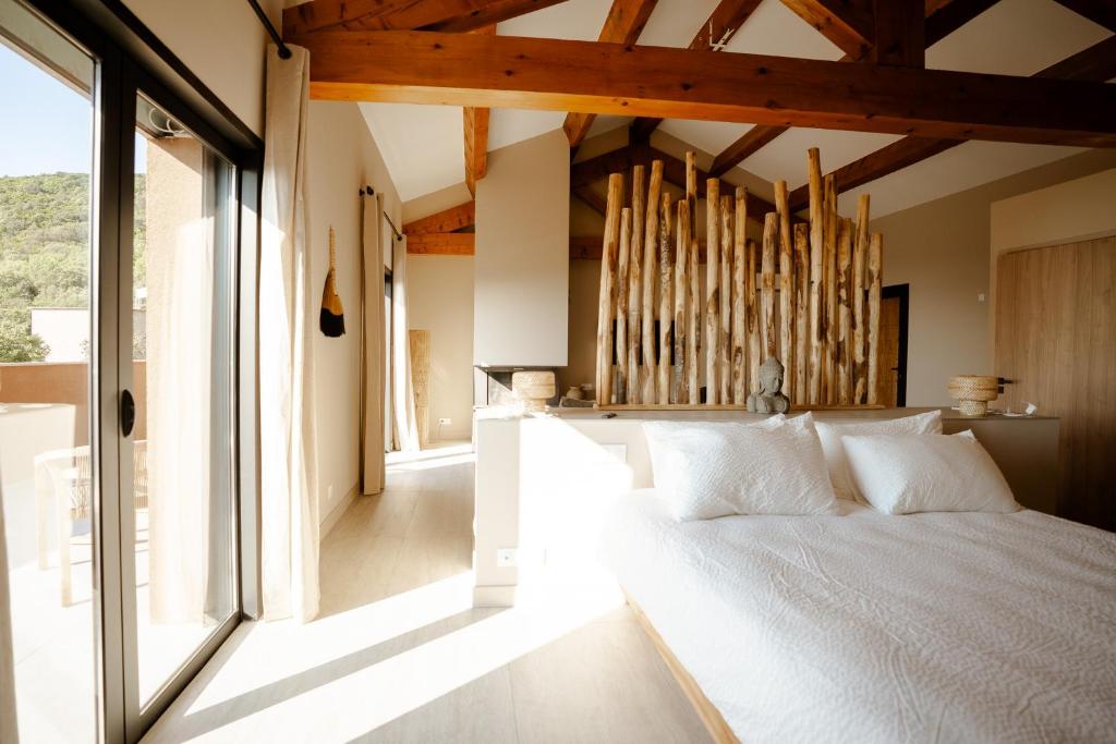a bedroom with a white bed and a large window at Casamore in Meria
