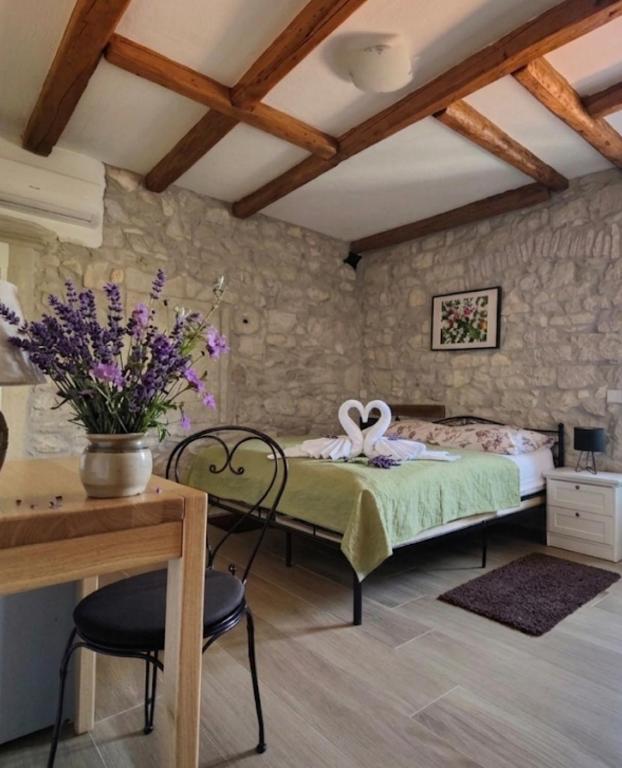 a bedroom with a bed and a table and chairs at Castello Gulich in Poreč