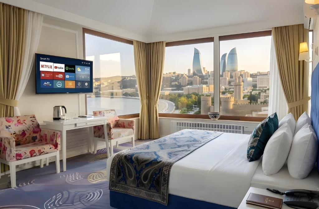 a hotel room with a bed and a large window at Senator panoramic Hotel in Baku
