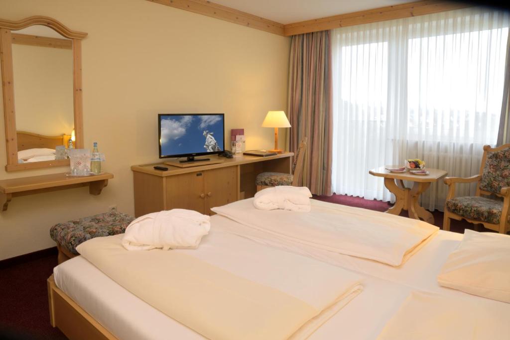 Postel nebo postele na pokoji v ubytování Hotel Kaiseralm