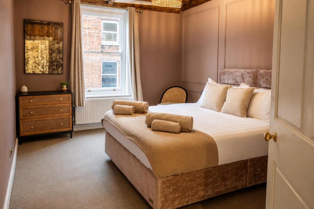 a bedroom with a large bed and a window at The Castle City Centre Apartment in Canterbury