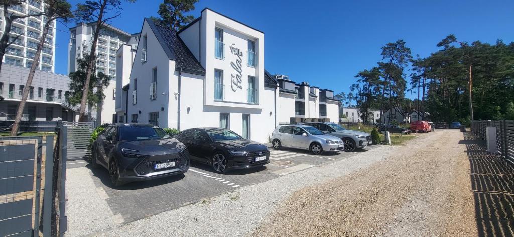 a group of cars parked in front of a building at Villa Fala in Dziwnówek