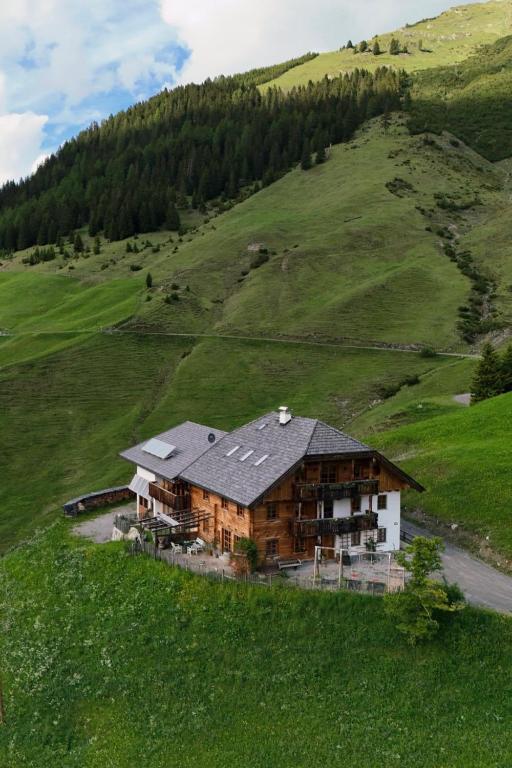a house on a hill in a green field at Bichlhof in Kaisers