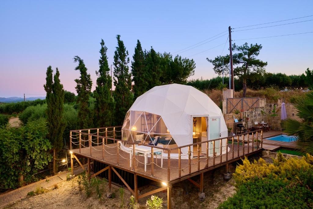a dome tent on a deck in a garden at Geo heaven glamp in Aïtánia