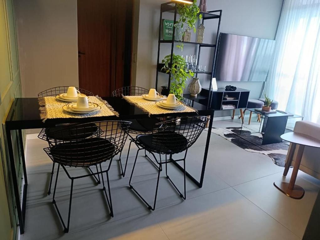 a dining table and chairs in a living room at LK Funcionários 6 in Belo Horizonte