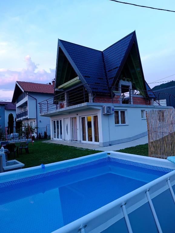 a house with a swimming pool in front of it at A&H Pliva Retreat in Jajce