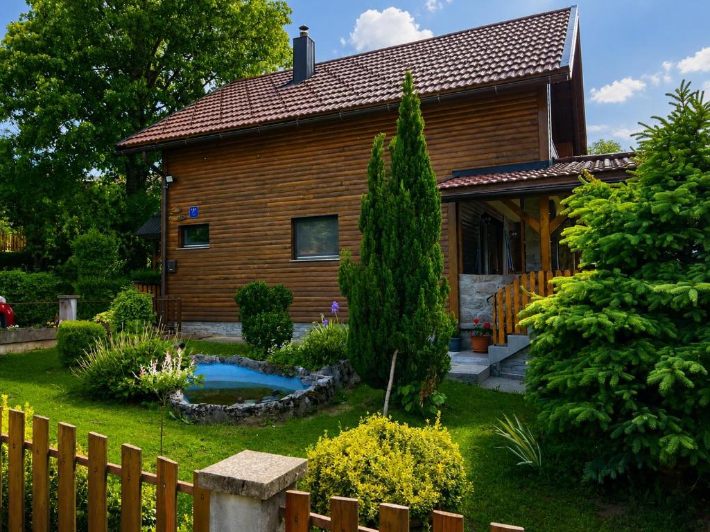 a wooden house with a pool in the yard at Kuća za odmor ANAMARIJA in Ogulin
