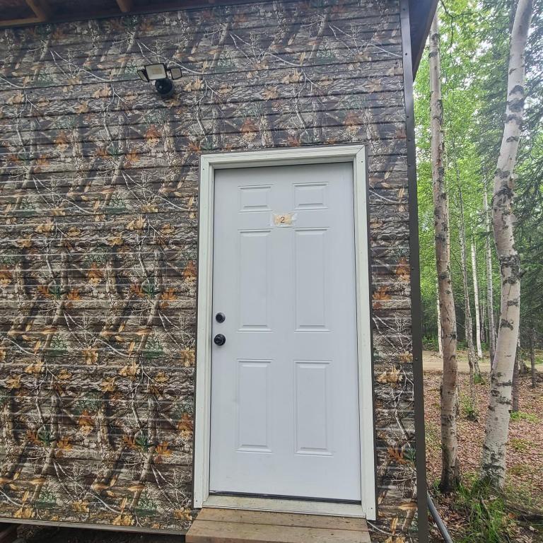 a white door on the side of a building at Happy Trails Hideout #2 in Houston