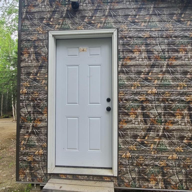 a white door on the side of a building at Camo Cabin #4 in Houston