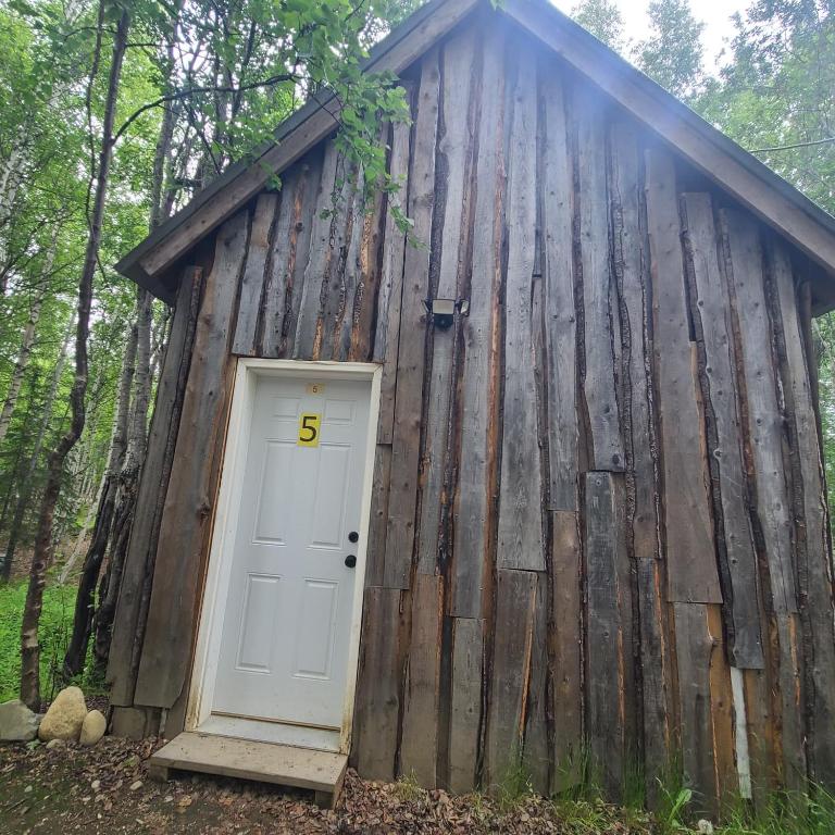 a wooden building with a door with the number at Rustic Family Bunk #5 in Houston