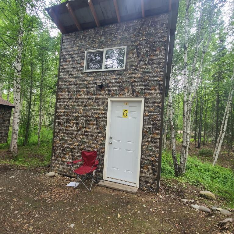 a brick building with a door and a red chair at Vibing In The Woods #6 in Houston
