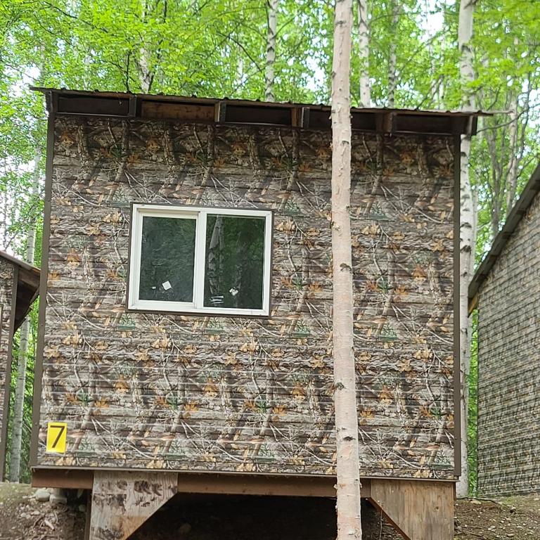 a building with a window on the side of it at Camo Getaway Cabin #7 in Houston