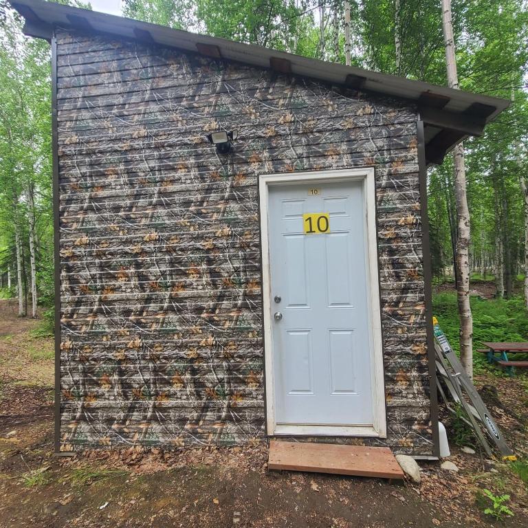 a small building with a door with the number no at Camo Hideout Cabin #10 in Houston