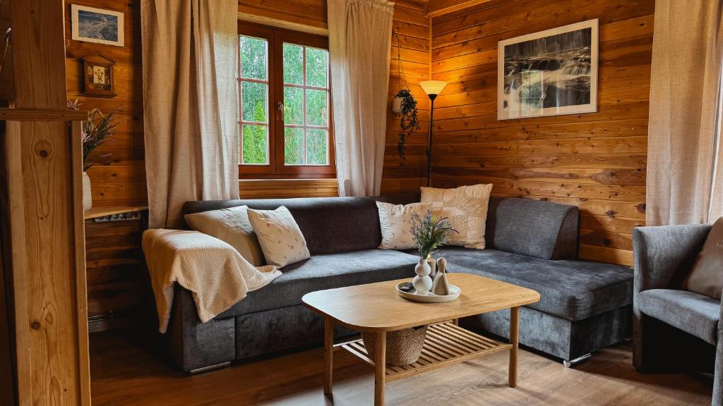 a living room with a couch and a table at Chatka Wald in Kostrzyca
