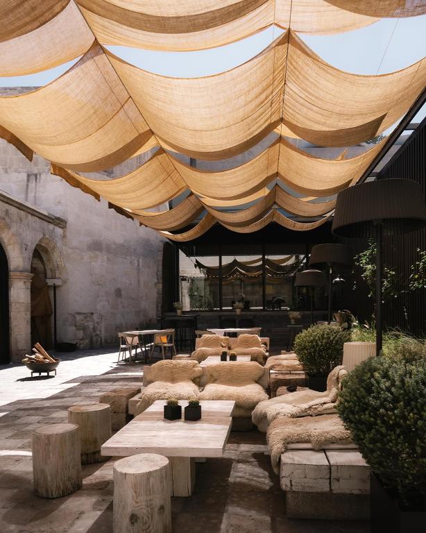 a large room with tables and chairs under a tent at CIRQA - Relais & Châteaux in Arequipa