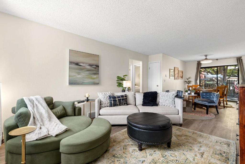 a living room with a couch and a table at Backyard Hideaway with King Bed, Garage, Bicycles in Loveland