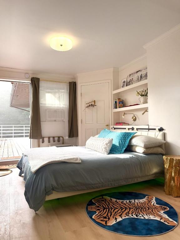 a bedroom with a bed and a rug on the floor at Catskill Apartment, Little Love Bird #5 in Shandaken