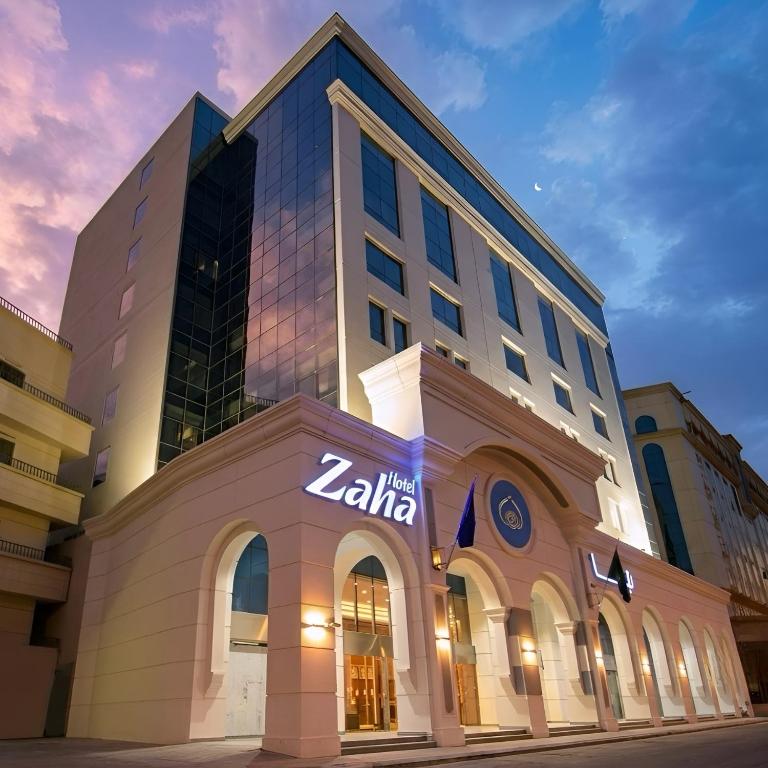 a building with a sign on the front of it at Zaha Al Munawara Hotel in Medina