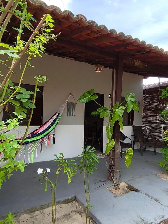 a patio of a house with a roof at Villa of the Palm Trees in Icaraí