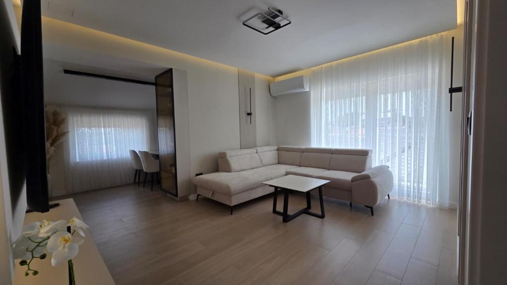 a living room with a couch and a table at Apartman Premium Posušje in Posušje