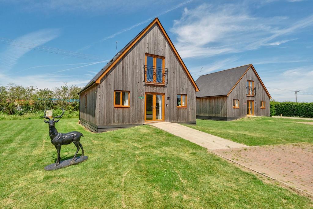 a house with a statue of a deer in front of it at Sage Lodge in Brigg