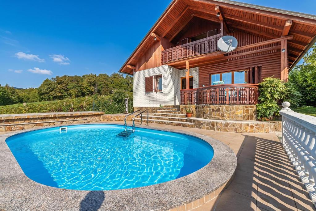 a pool in front of a house at Pool Chalet Adonis w/ Panoramic Views - Happy Rentals in Semič