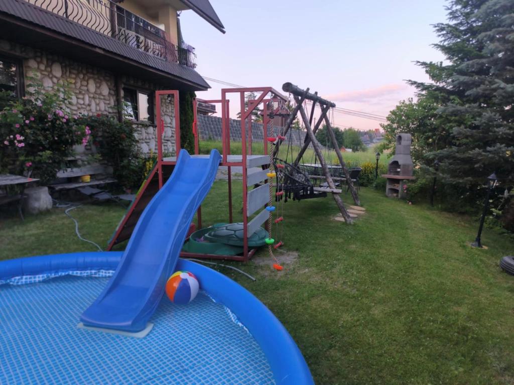 a playground in a yard with a slide at Pokoje Janka Gliczarów Górny in Gliczarów