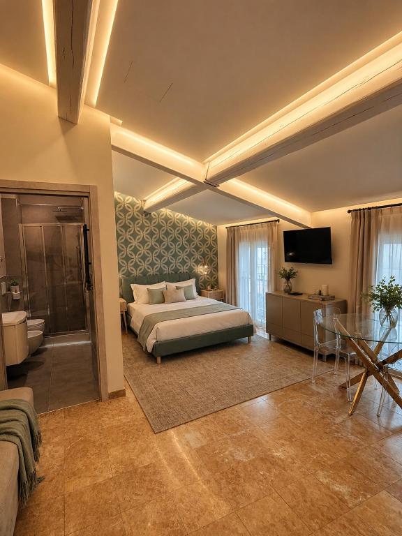 a large bedroom with a bed and a bathroom at Galeo Suites in Florence