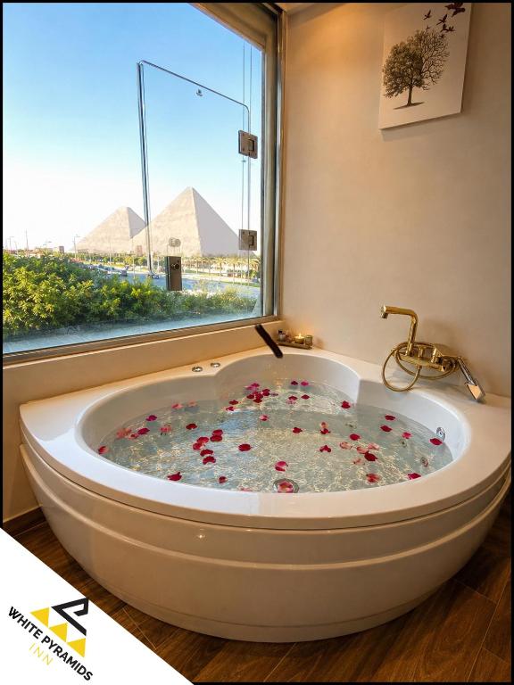 a bath tub in a room with a window at New White Pyramids Inn in Cairo