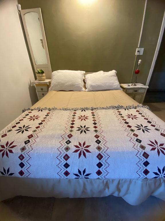 a bed with a quilt on it in a room at La Casona de Emilia in Corrientes