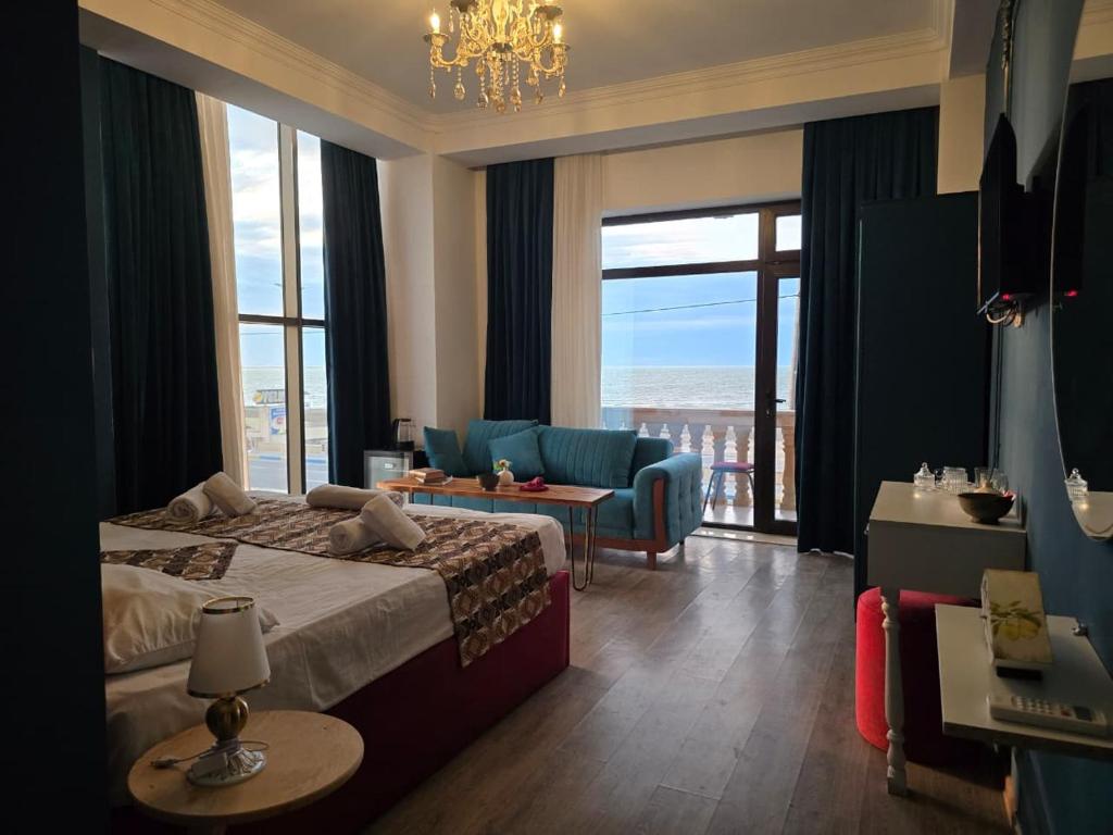 a hotel room with a bed and a view of the ocean at NovArt Gallery Hotel in Sumqayıt