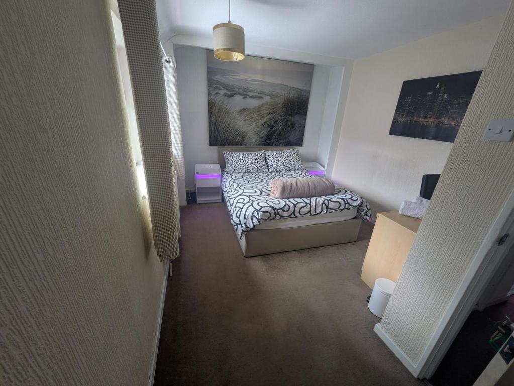 a small room with a bed and a couch at Bramcote House in Bramcote