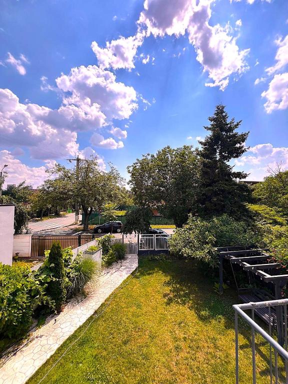 a view of a park with a fence and trees at Elite Residence - Modern 2BR - Sleeps 6 - FREE Parking in Timişoara