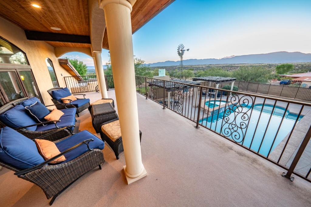a balcony with chairs and a swimming pool at Sorelle Vineyard in Cornville