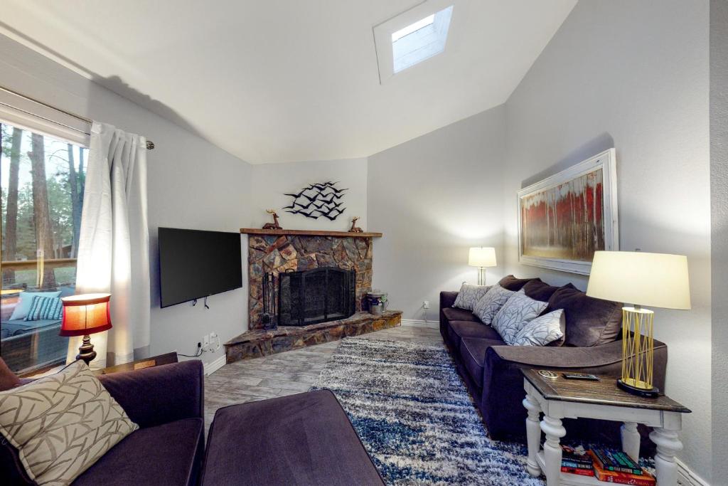 a living room with a couch and a fireplace at Cozy Mountain Townhome in Flagstaff