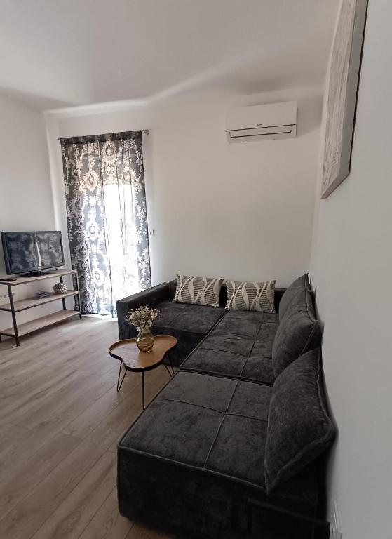 a living room with a couch and a table at Apartment Hidden Garden in Pula