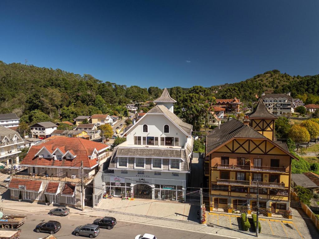 an aerial view of a town with a mountain at Pousada Sol da Mantiqueira in Campos do Jordão