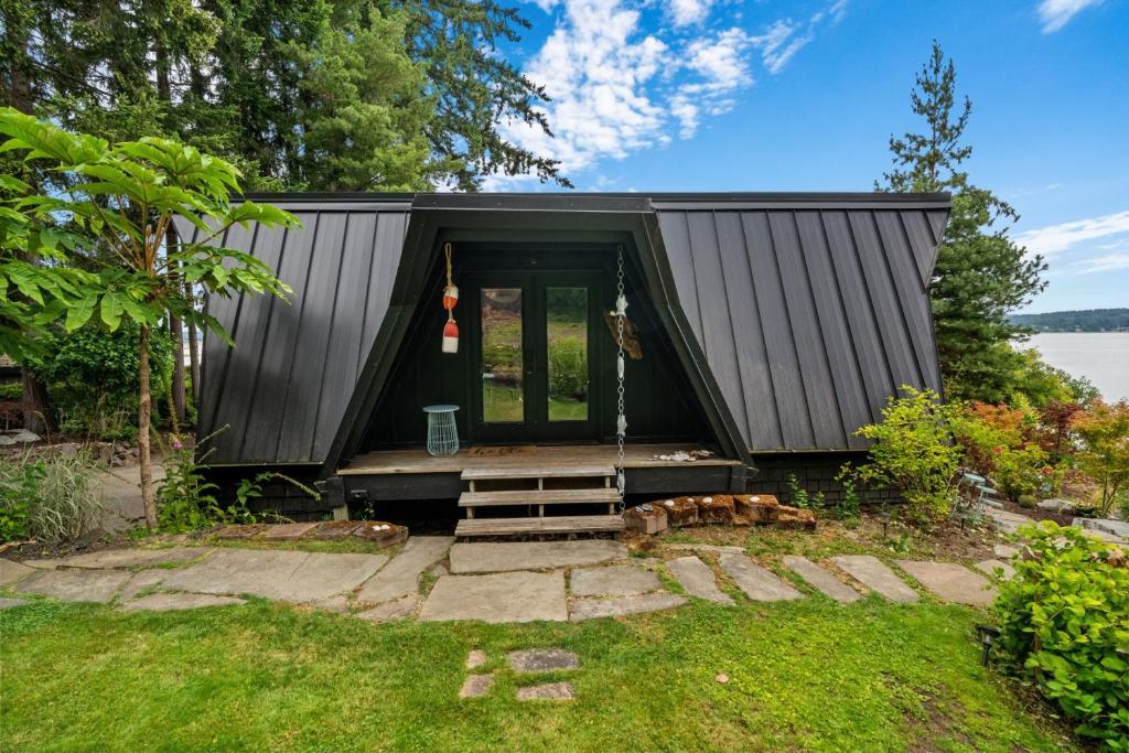 a tiny house with a black exterior at The Loft | Beach | Kayaks & Pickleball in Bremerton