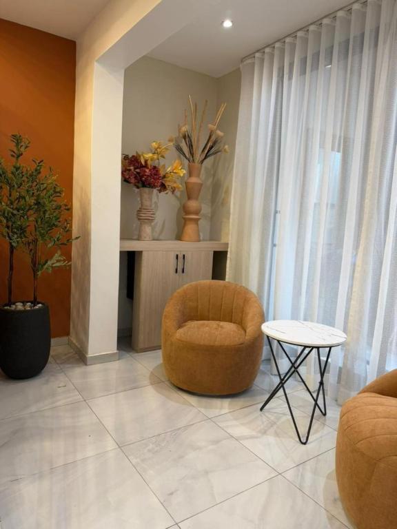 ein Wohnzimmer mit einem Stuhl und einem Tisch in der Unterkunft Kadiss Hotel in Dakar