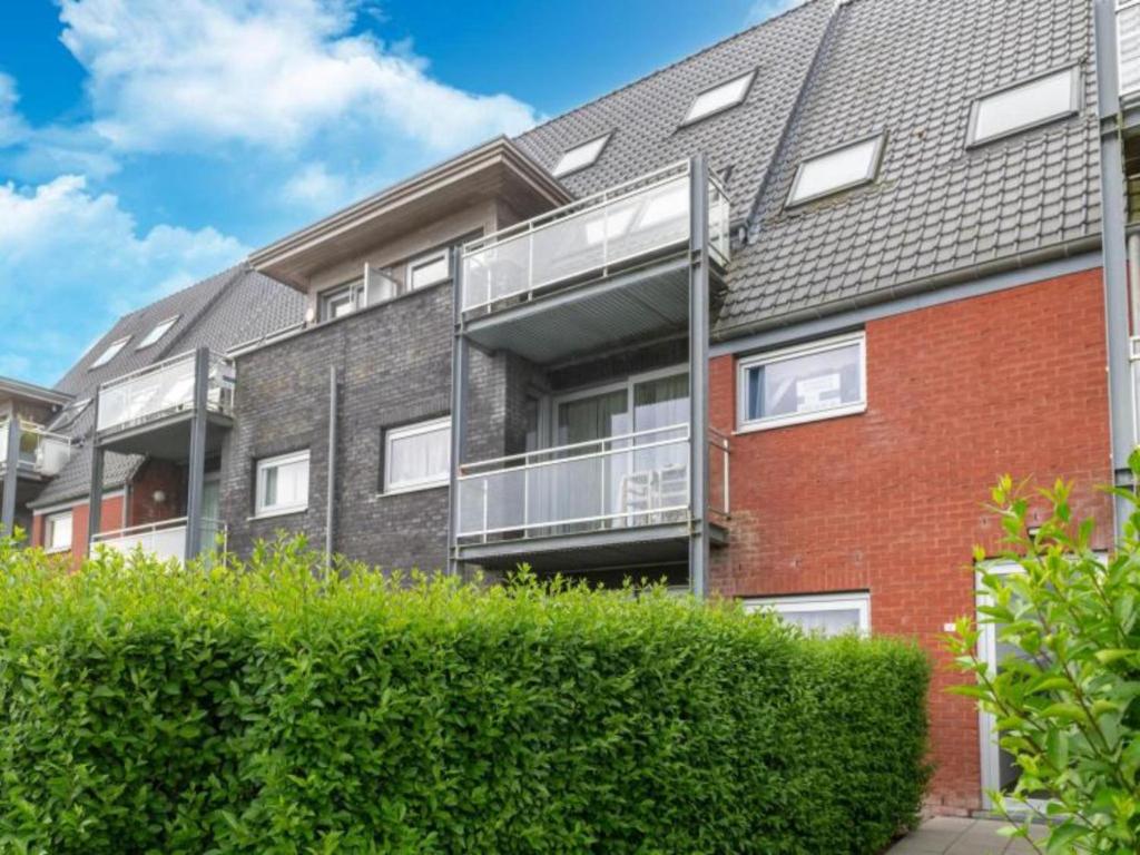 an apartment building with balconies on the side of it at Nieuwendamme 40C in Lombardsijde
