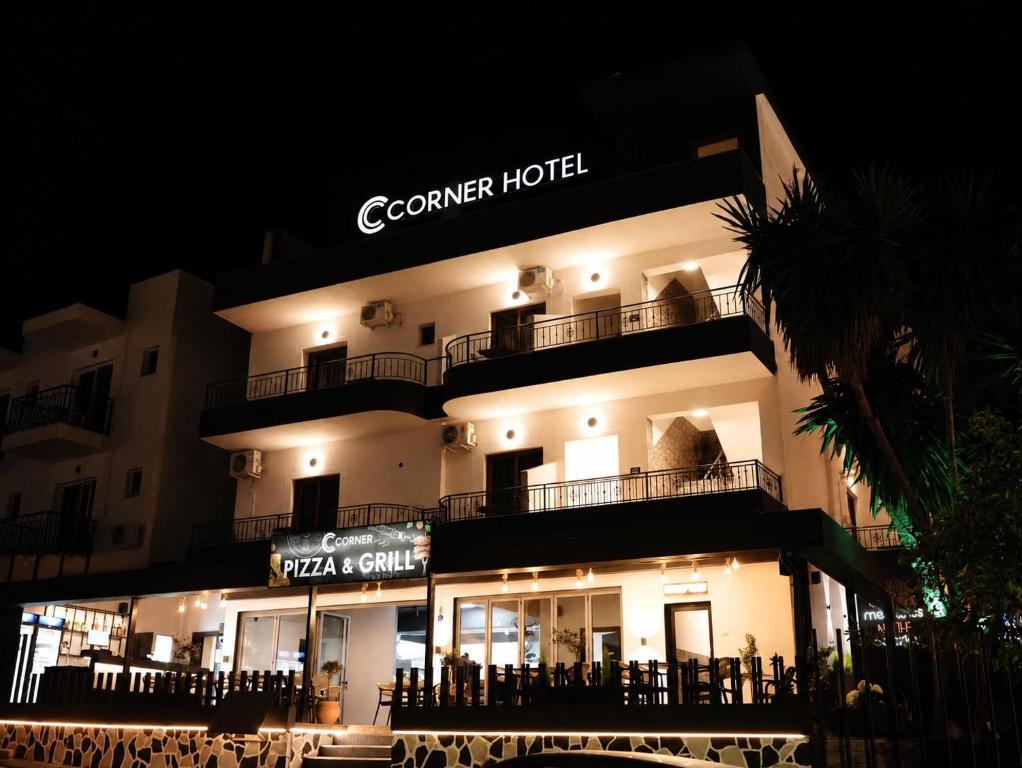 a building with a sign that reads corona hotel at Corner Hotel in Ksamil