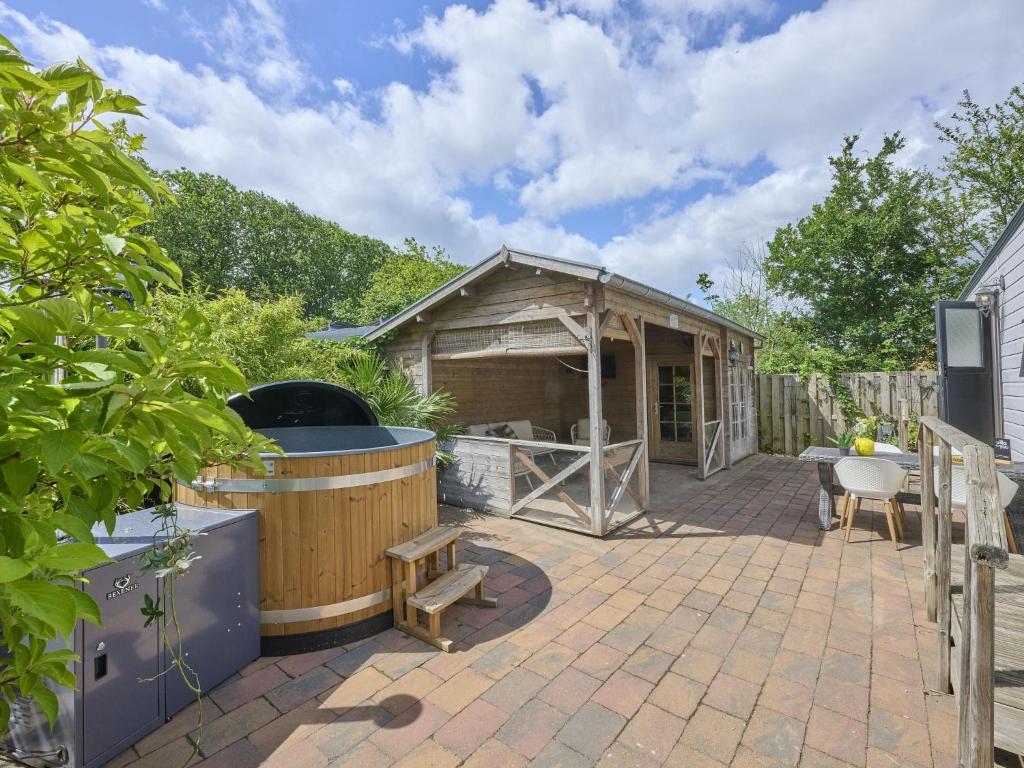 a backyard with a hot tub and a gazebo at t Kaatsheuveltje 9 in Kaatsheuvel