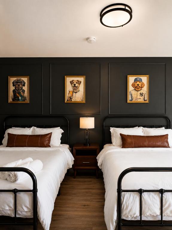 two beds in a bedroom with black walls at KC's Corner Motel in East Springfield