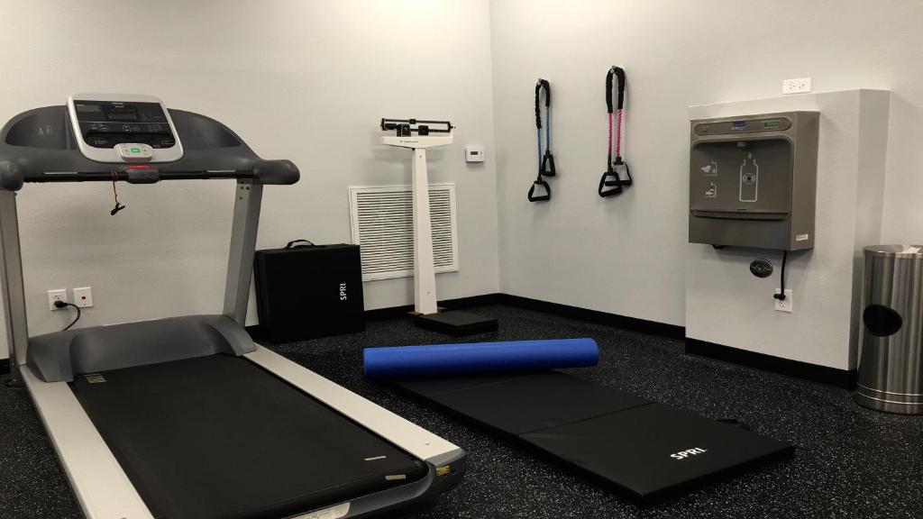 a fitness room with a treadmill and a machine at Holiday Inn Express Hotel & Suites - Paso Robles by IHG in Paso Robles