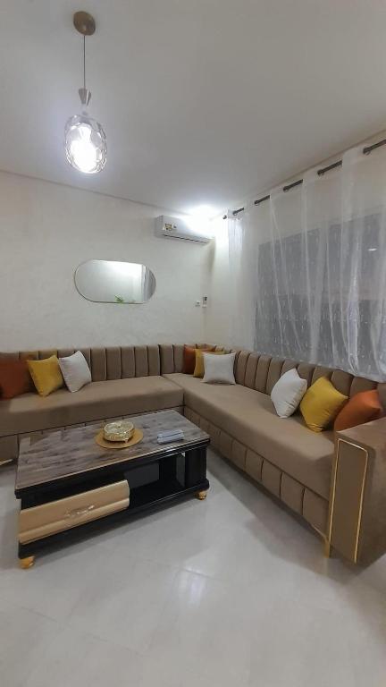 a living room with a couch and a coffee table at Rouge Azur Saidia in Saïdia