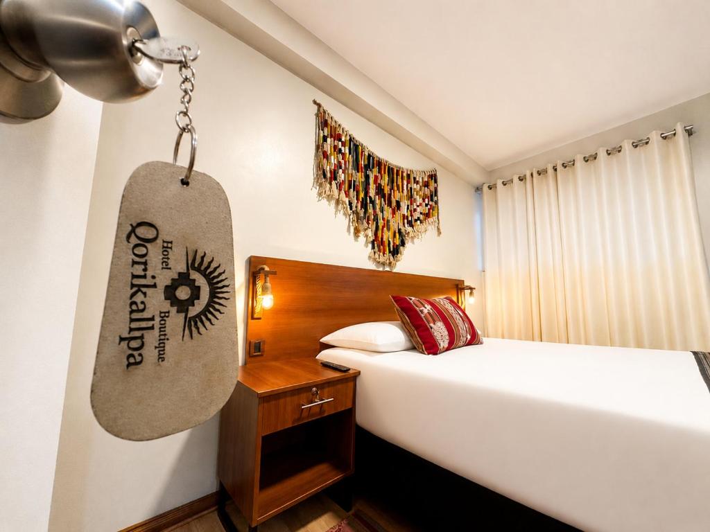 a bedroom with a bed and a skateboard hanging on the wall at Cusco - Perú "Hotel Boutique Qorikallpa" The true essence of inka culture in Cusco